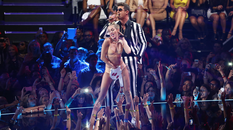 Miley Cyrus and Robin Thicke performing