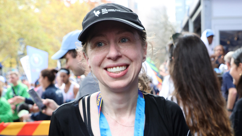 Chelsea Clinton smiles in baseball cap