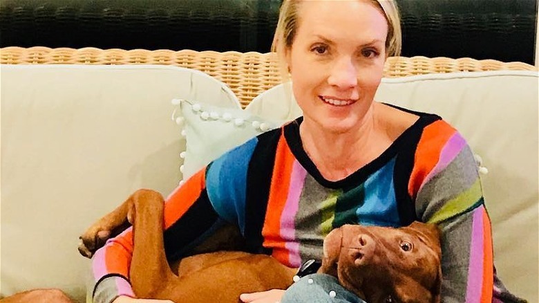 Dana Perino without makeup holding dog