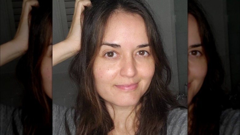 Danica McKellar with hand on side of head