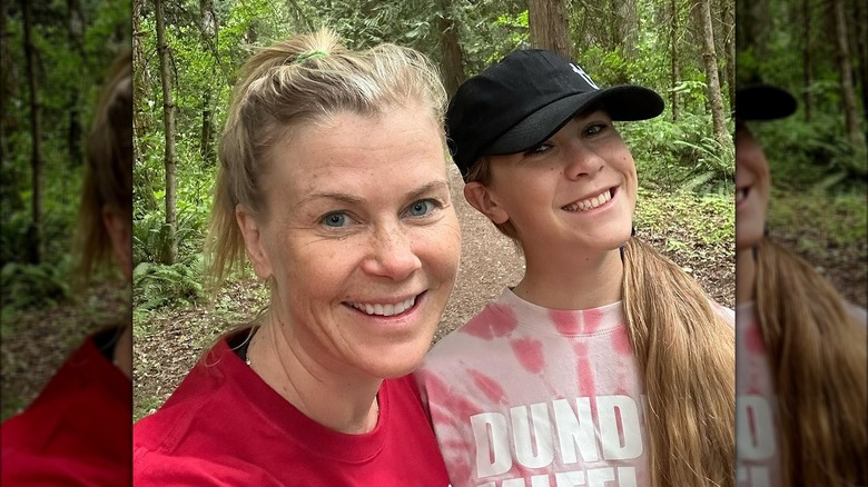 Alison Sweeney, daughter smiling outdoors