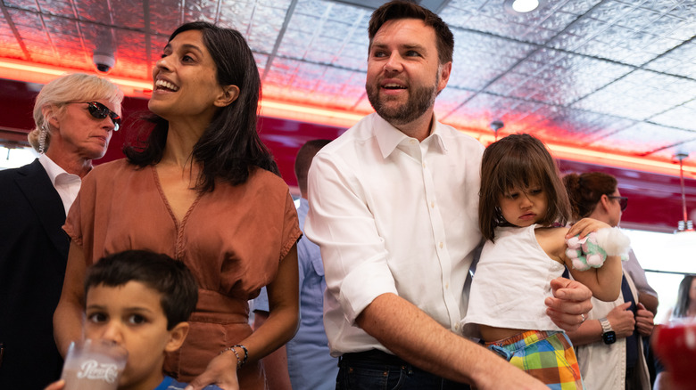 Usha Vance, JD Vance, and two of the couple's three children talking with employees at a diner in Minnesota
