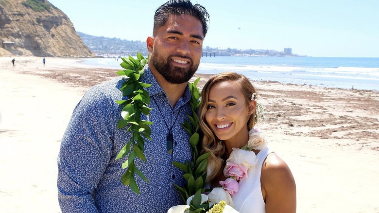 Manti Te'o and Jovi Nicole posing on beach