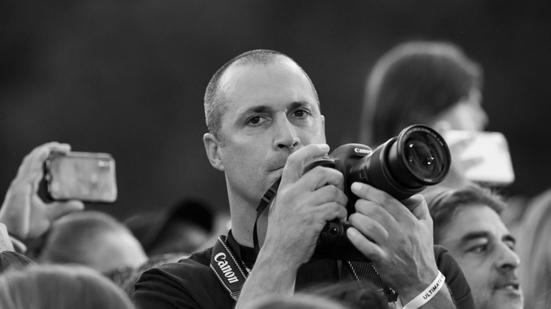Nigel Barker holds his camera