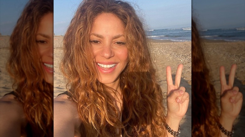 Shakira throwing peace sign