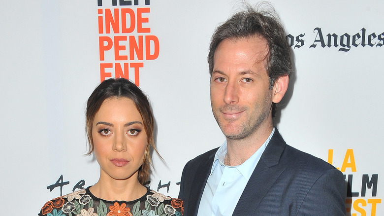 Aubrey Plaza and Jeff Baena posing together