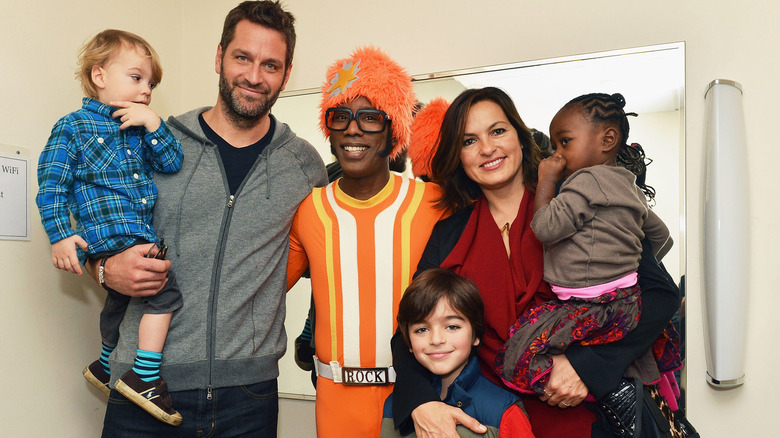 Peter Hermann and Mariska Hargitay posing with their kids and DJ Lance Rock