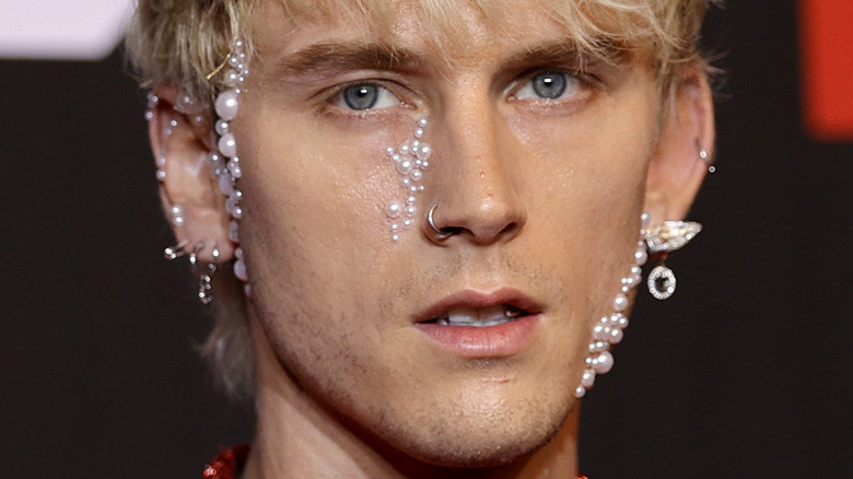 Machine Gun Kelly wearing pearls