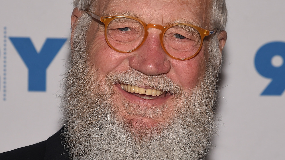 A bearded David Letterman smiling 