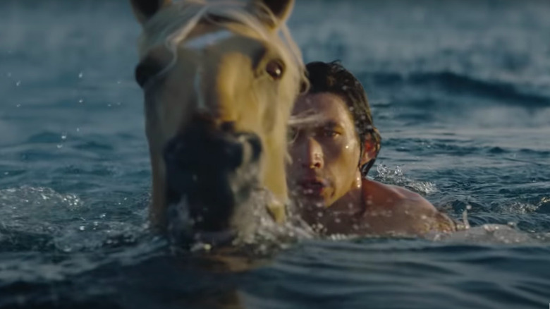 Adam Driver in water with horse