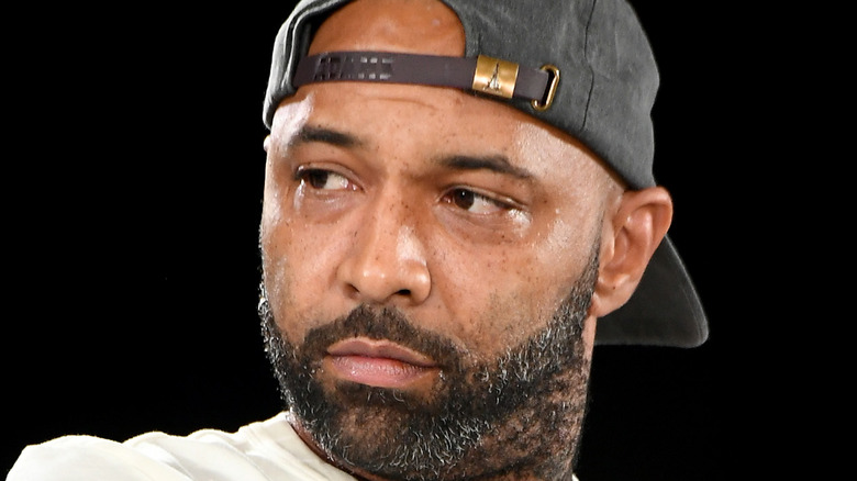 Joe Budden looking to the side with displeased expression