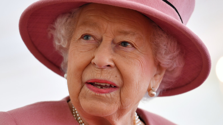 Queen Elizabeth II wearing pink hat