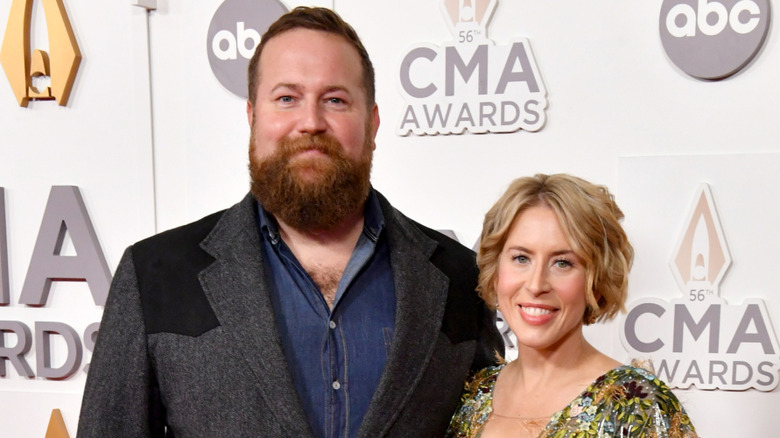 Erin Napier sports a radiant smile while Ben Napier wears a restrained look on the red carpet