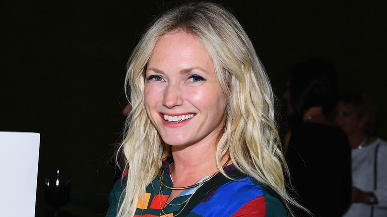 Emily Henderson photographed in front of a dark background