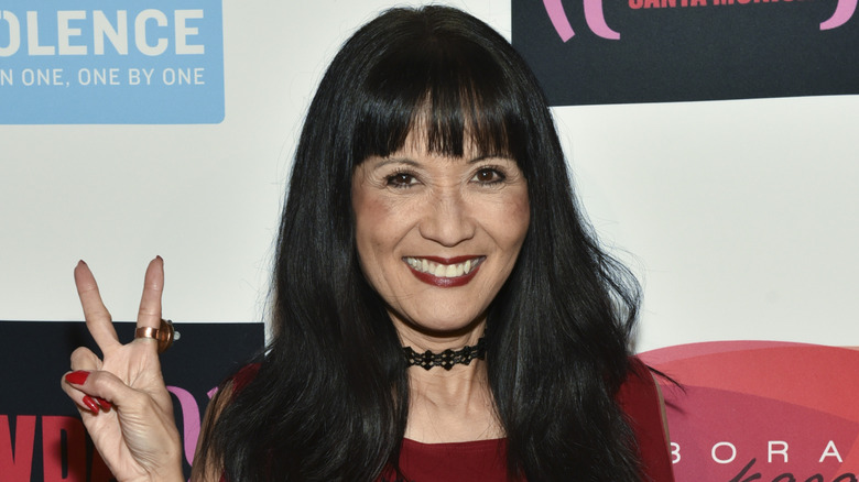 Suzanne Whang flashing a peace sign