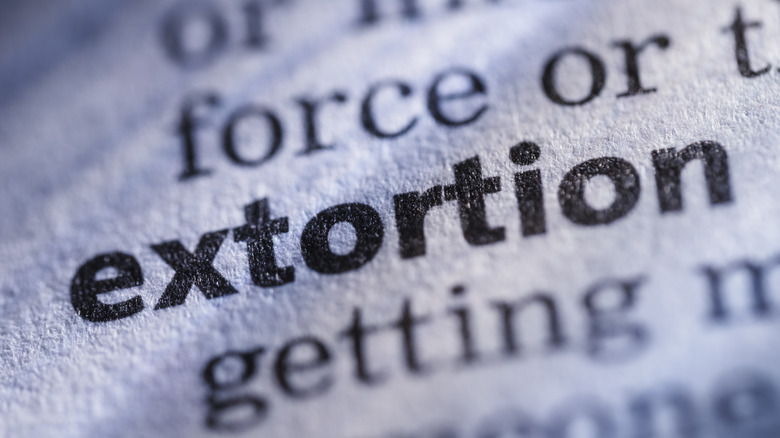 The word 'extortion' written in dictionary