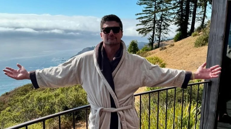 Joshua Hall posing for cameras on hillside