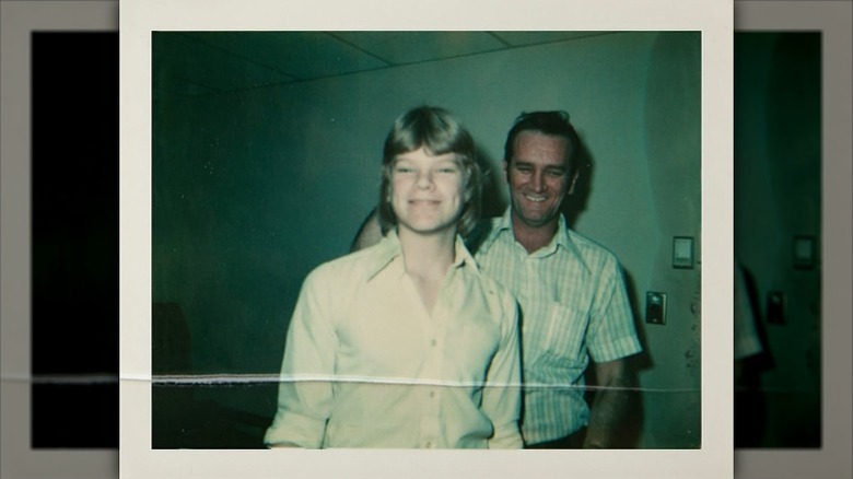 Mike Holmes' mother smiles with her husband behind her