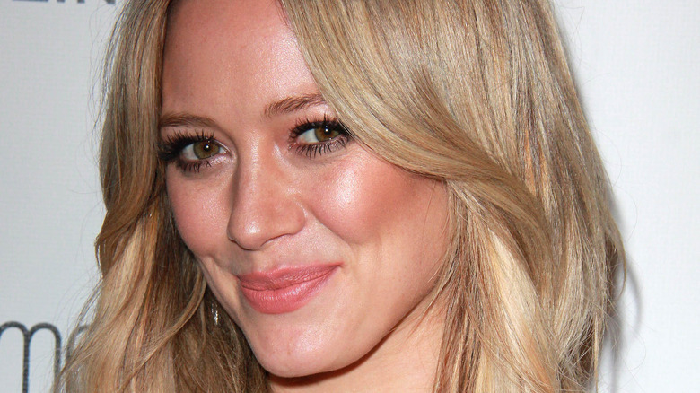 Hilary Duff smiling in front