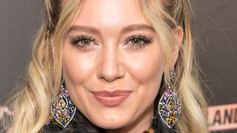 Hilary Duff smiling in front