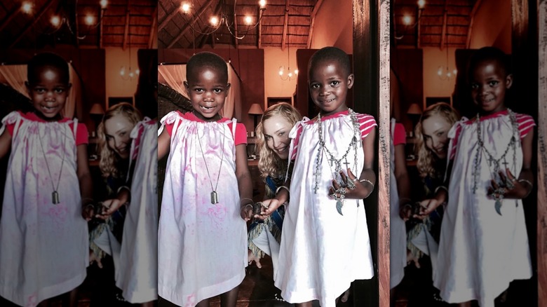 Madonna posing with twins, Estere and Stella