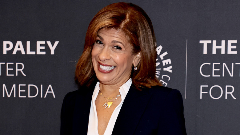 Hoda Kotb smiles in a black blazer and white blouse