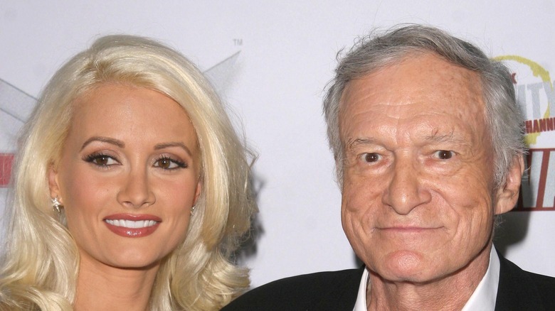 Hugh Hefner and Holly Madison posing on red carpet