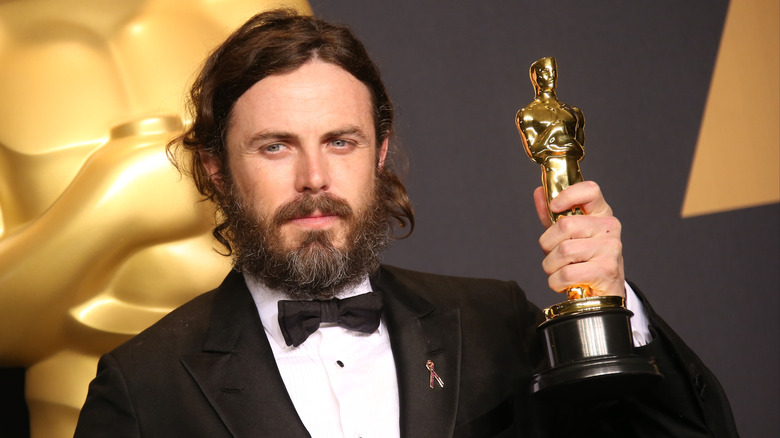 Casey Affleck holding Oscar