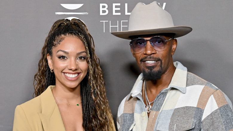 Jamie Foxx and Corinne Foxx posing at an event