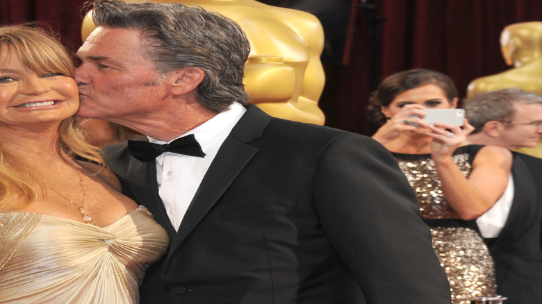 Kurt Russell kissing Goldie Hawn's cheek