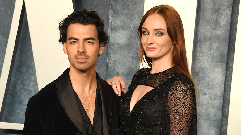 Sophie Turner with hand on Joe Jonas' shoulder