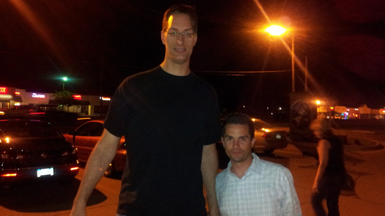 Mike Lanier posing with fan in parking lot