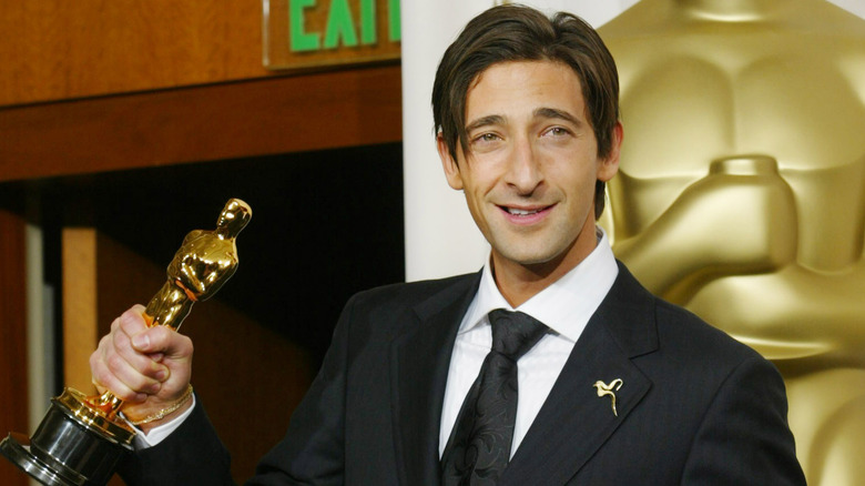 Adrien Brody holding up his Oscar