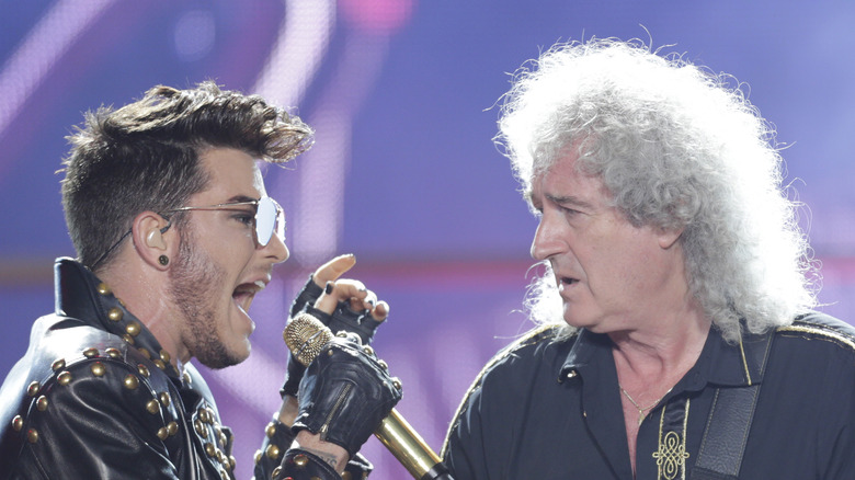 Adam Lambert sings on stage with Brian May
