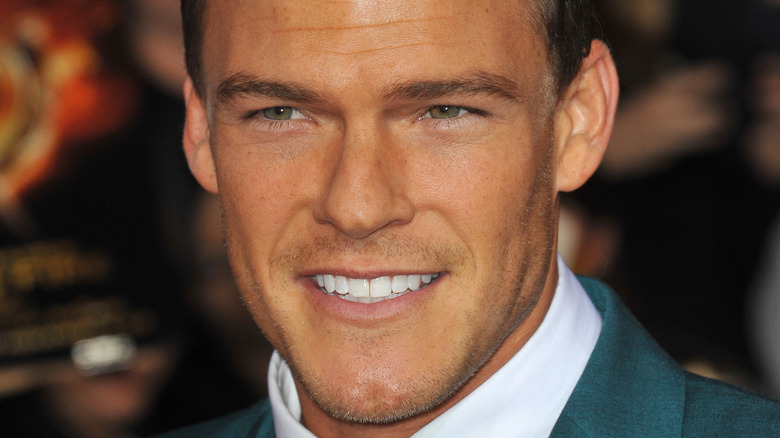 Alan Ritchson poses