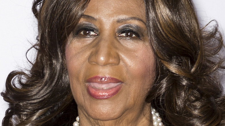 Aretha Franklin smiling on red carpet