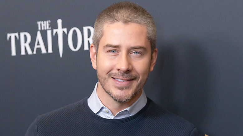 Arie Luyendyk Jr. posing at 'The Traitor' event