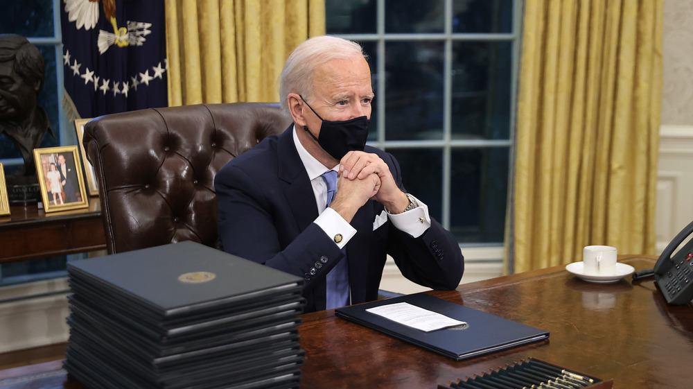 President Joe Biden sitting in the Oval Office