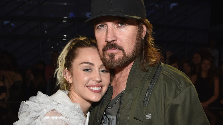 Billy Ray Cyrus cuddling up to Miley Cyrus