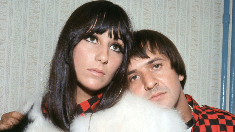 Cher & Sonny Bono putting their heads together while posing for a photo