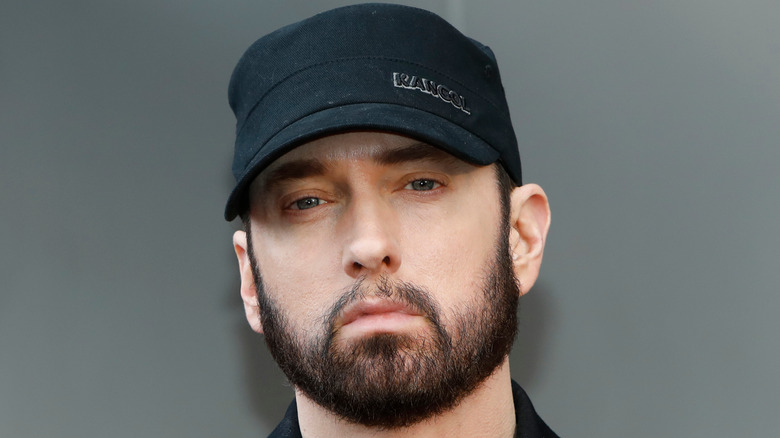 Eminem wearing a black hat