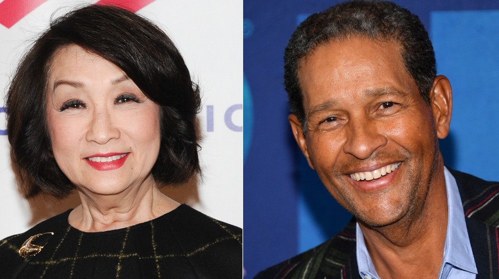 Connie Chung, smiling, black top and red lipstick; Bryant Gumbel smiling, collared shirt, no facial hair