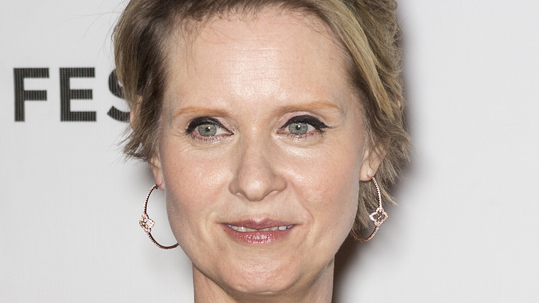 Cynthia Nixon with soft smile looking away from camera