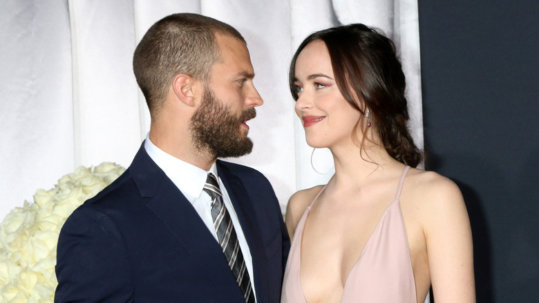 Jamie Dornan and Dakota Johnson looking at one another