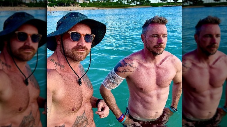 Dax Shepard poses shirtless with a friend