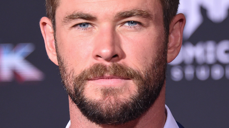 Chris Hemsworth poses in a blue suit