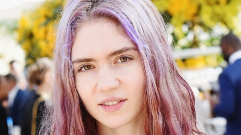 Grimes slightly smiling and looking at camera