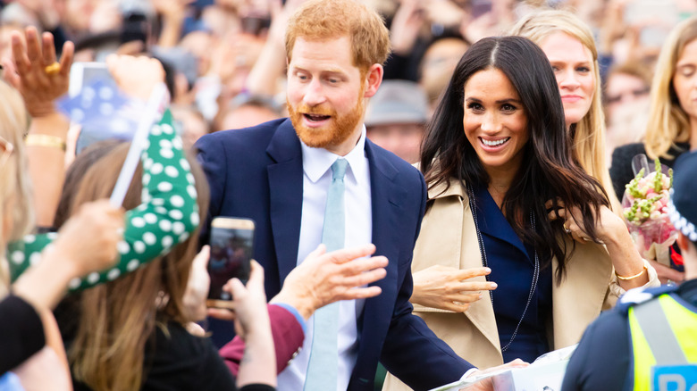 Prince Harry Meghan Markle walking in crowd