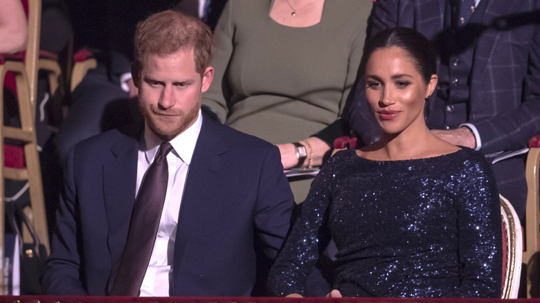 Prince Harry and Meghan Markle looking down