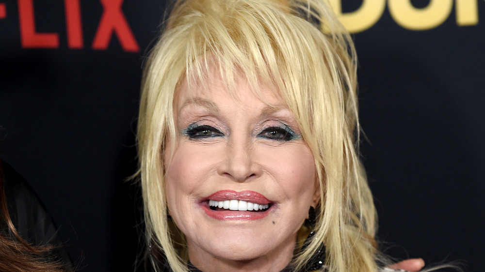 Dolly Parton smiling on a red carpet